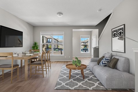 a living room and dining room with a couch and a table